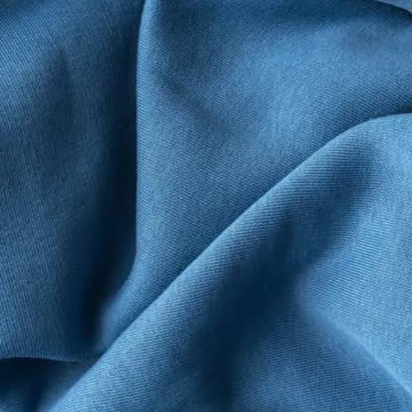 Soft blue cotton fleece fabric in loose folds