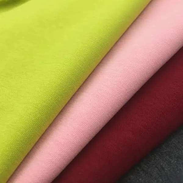Folded sweatshirt fabric in lime, pink and red