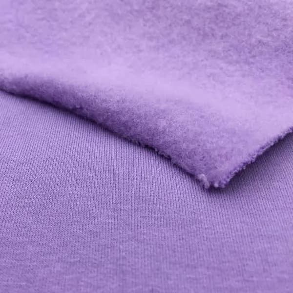 Lilac fleece fabric with the brushed inside folded over the smooth face